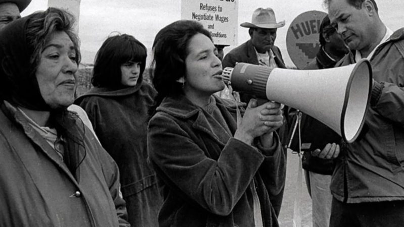 Activist Dolores Huerta speaking into a megaphone